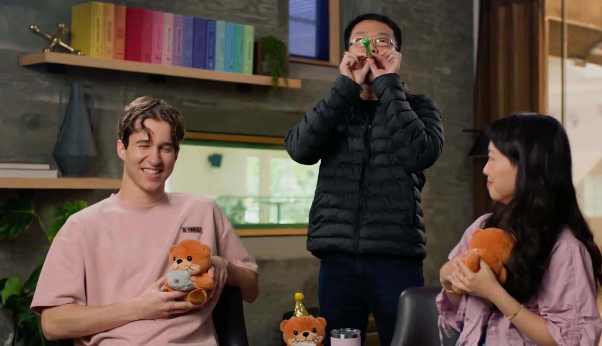Nick and teammates celebrating with stuffed otters at the Cognition office